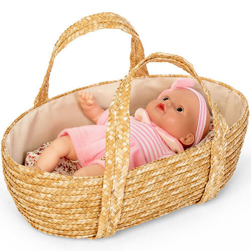 mini mommy poppenreiswieg van stro met een baby pop in roze kleding liggend op gebloemd beddengoed.