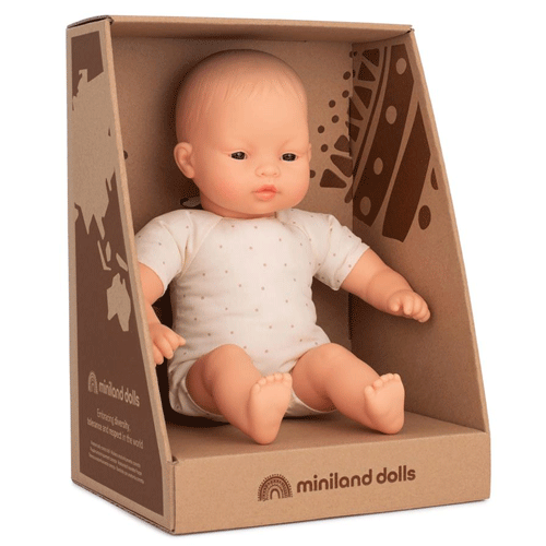 Miniland babypop met Aziatische kenmerken in de kartonnen verpakking.