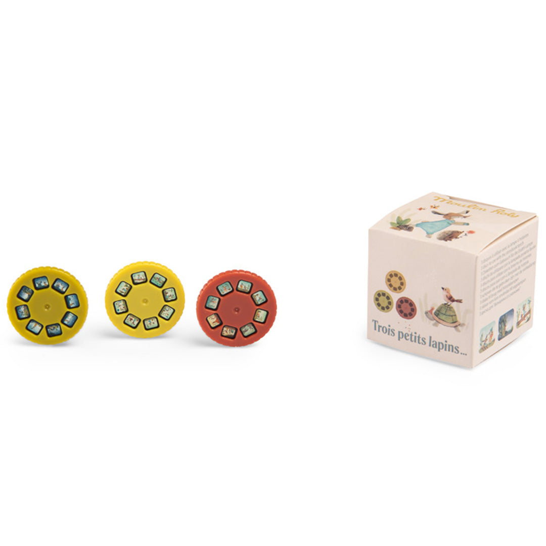 Moulin Roty discs voor projector bedtijdverhalen met drie gekleurde schijven en de verpakking met konijnen.