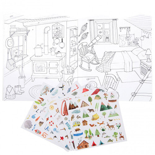 Open Moulin Roty kleurboek met zwart-wit tekeningen van een interieur en losse vellen met kleurrijke stickers.