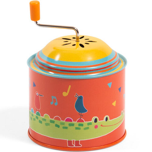 Moulin Roty muziekspeeldoos met een oranje basis, een krokodil en twee vogels.
