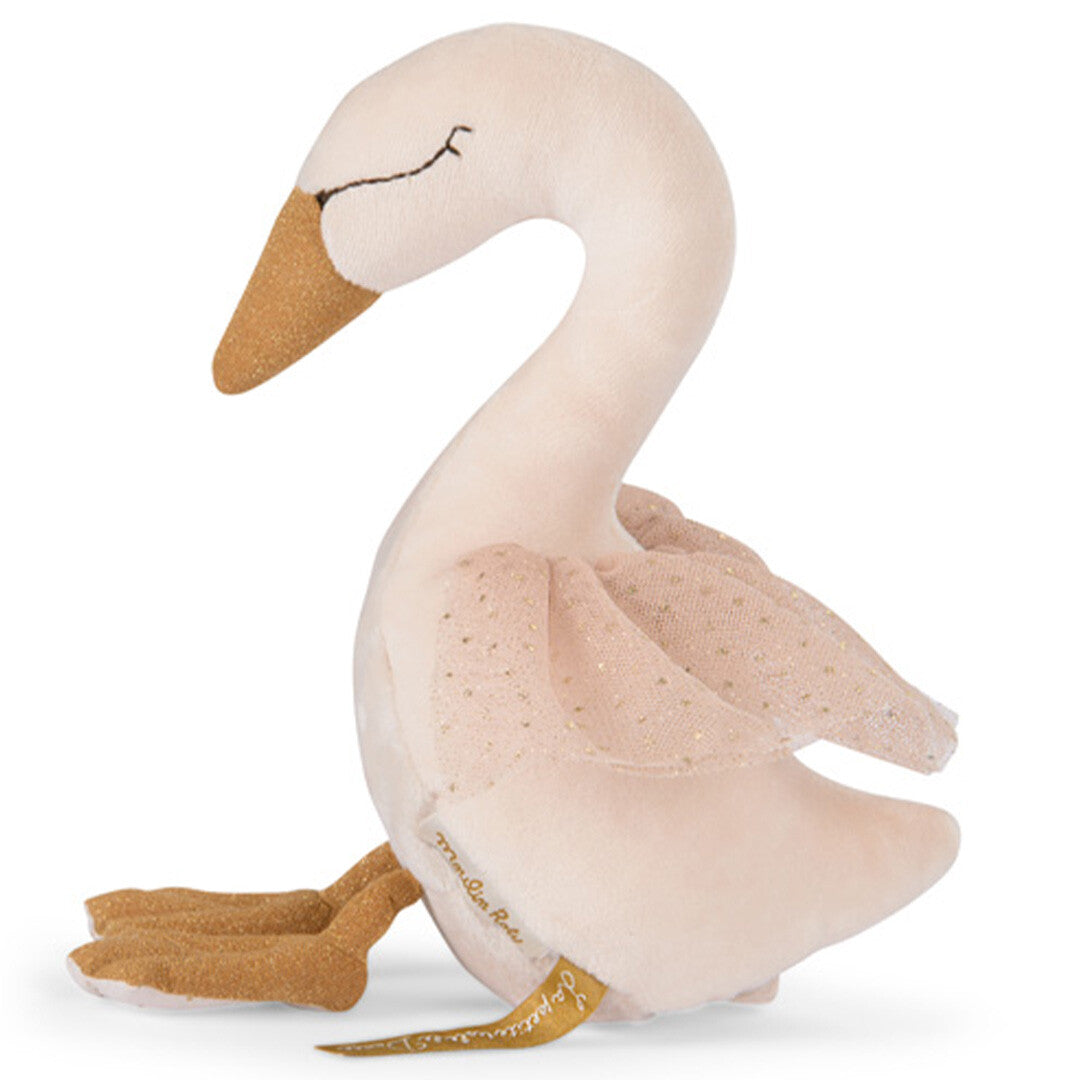Moulin Roty muziekspeelgoed zwaan van de zijkant, met beige lijf, gouden snavel en roze stof met stippen.