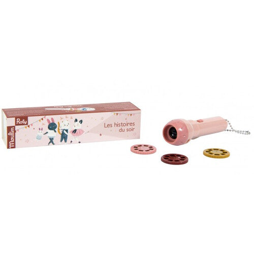 De roze Moulin Roty projector voor bedtijdverhalen met drie schijfjes en de verpakking.