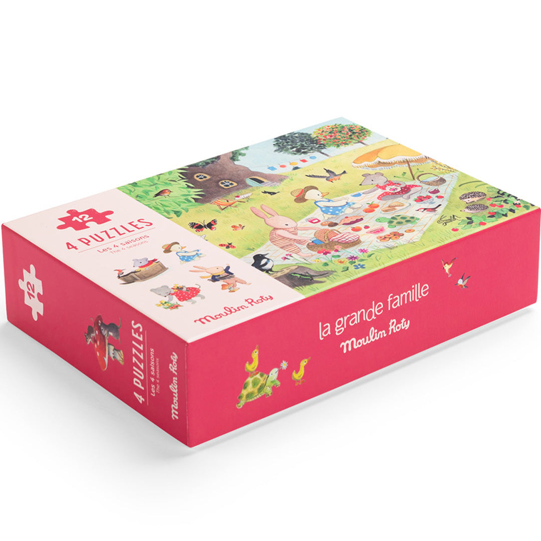 Moulin Roty legpuzzel set 'La Grande Famille' met dierenpicknick op de rode verpakking, schuin van bovenaf.