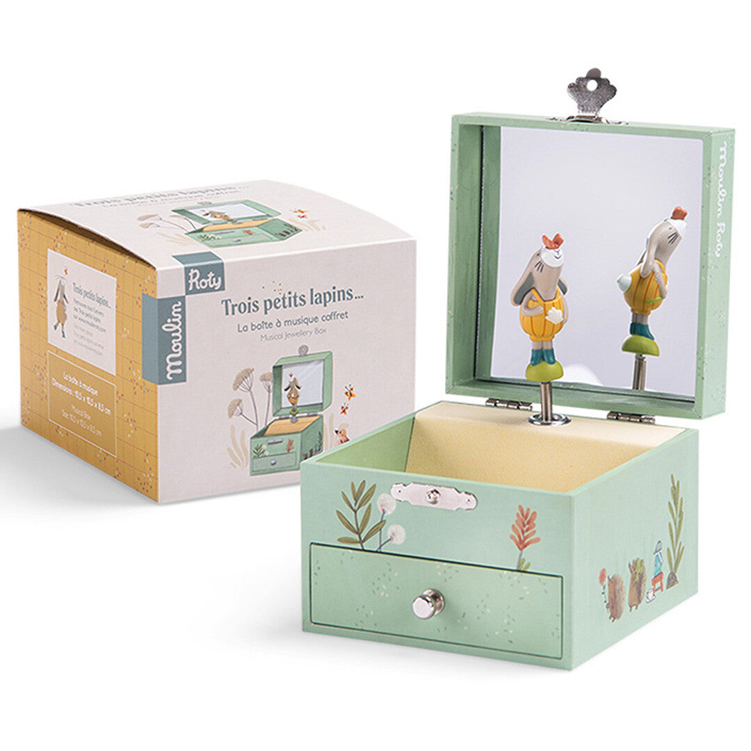 Moulin Roty muzieksieradendoosje met dansend konijn naast de productverpakking.