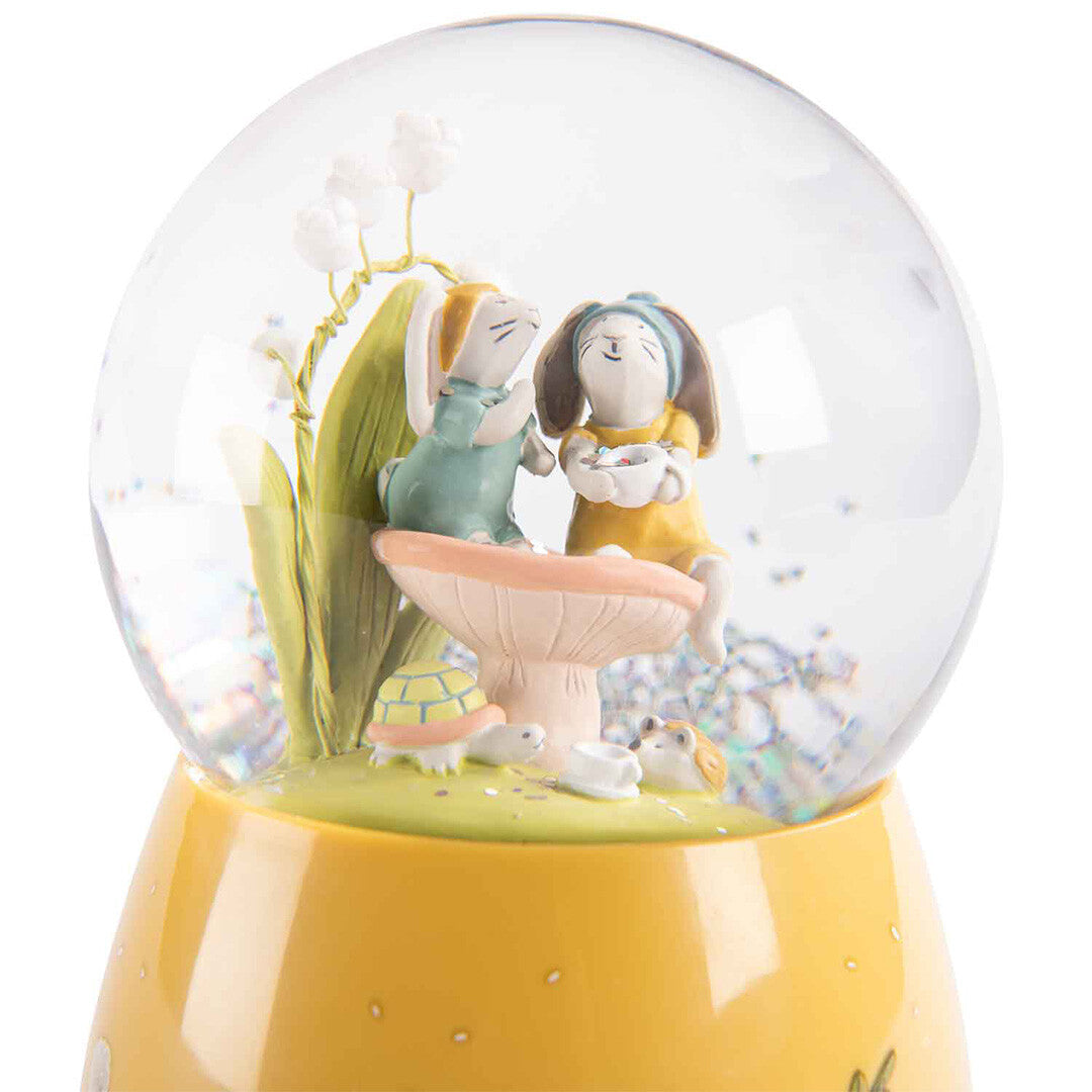 Vooraanzicht van de Moulin Roty sneeuwbol met twee konijntjes en een schildpad.