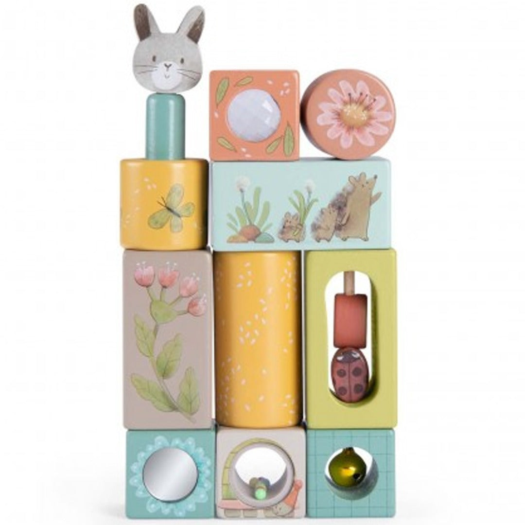 Moulin Roty houten babyspeelgoed bouwblokken met een konijnenhoofd, spiegels, rammelaars en diverse dieren- en bloemenillustraties.
