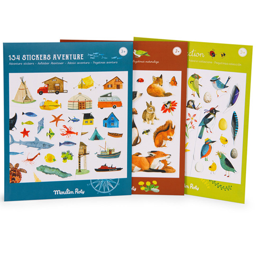 Drie verschillende Moulin Roty stickervellen, waaronder '154 Stickers Aventure', met thema's als avontuur, bosdieren en vogels.
