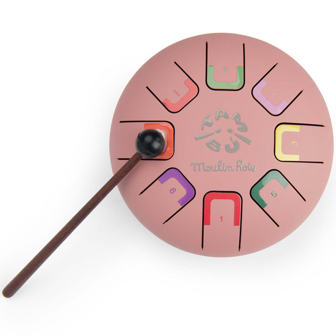 Moulin Roty roze metalen tongtrommel met gekleurde genummerde toetsen en een zwarte mallet.