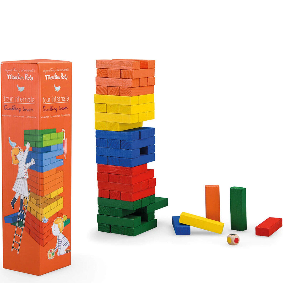 Moulin Roty torenspel met een toren van kleurrijke houten blokken, losse blokken, een dobbelsteen en de productverpakking.