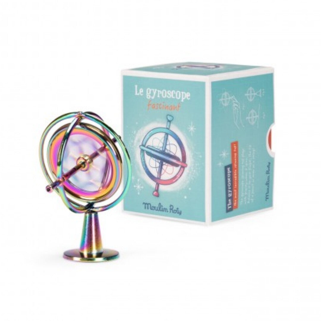 Moulin Roty regenboogkleurige gyroscoop op standaard naast de verpakking.