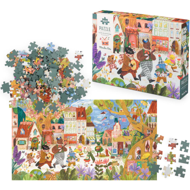 Moulin Roty legpuzzel van 500 stukjes met een afbeelding van musicerende dieren in een dorp, deels gelegd met losse stukjes en de verpakking ernaast.