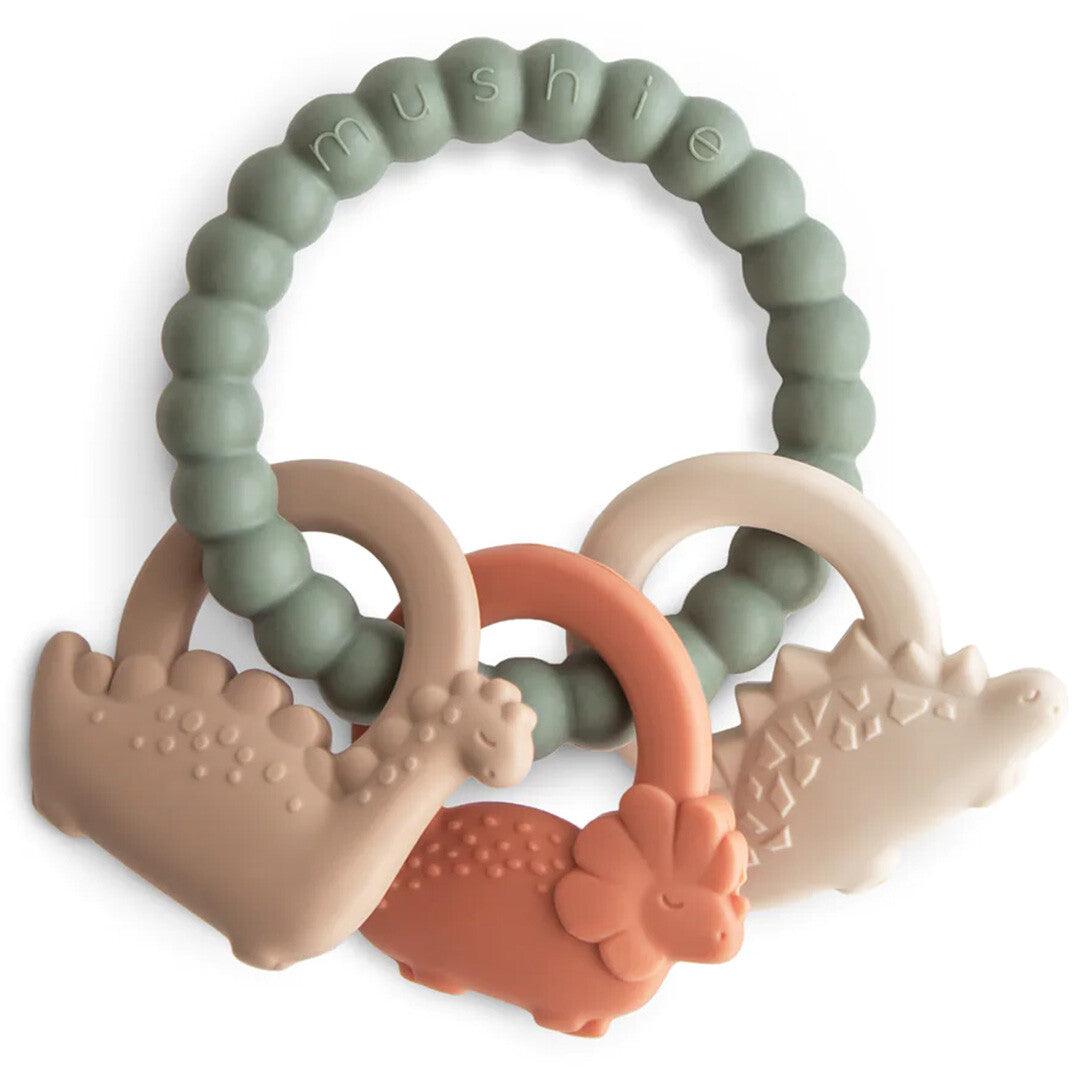 Mushie bijtspeelgoed met een groene ring en drie dinosaurusvormige bijtringen.