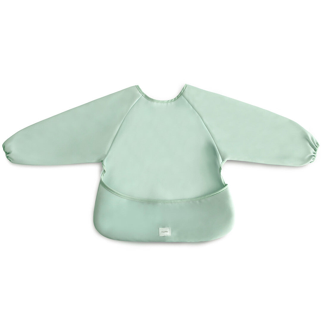 Mushie mouwslab in effen groen, plat liggend op een witte achtergrond.
