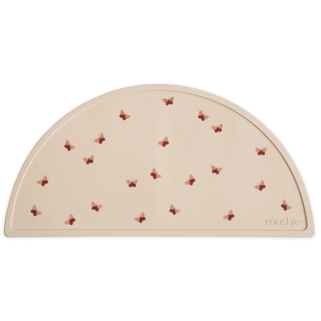 Mushie siliconen placemat voor baby's in beige met vlinderpatroon.
