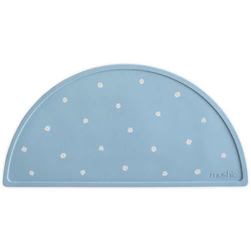 Mushie blauwe siliconen placemat met witte madeliefjespatroon.