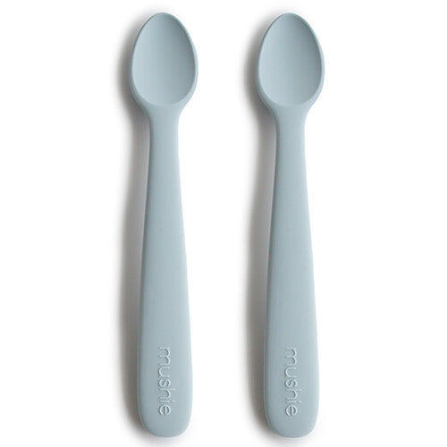Twee Mushie siliconen babylepels in de kleur powder blue.
