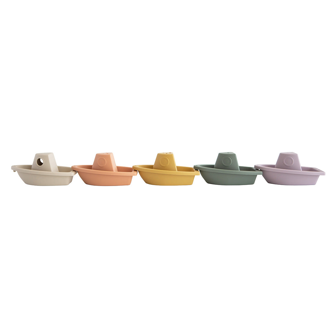 Vijf mushie badbootjes in verschillende kleuren, naast elkaar op een rij.