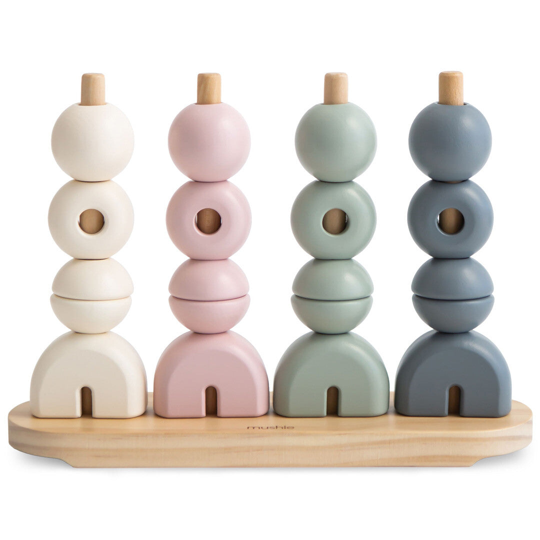 Mushie houten stapeltoren met vier staven en geometrische vormen in pastelkleuren.