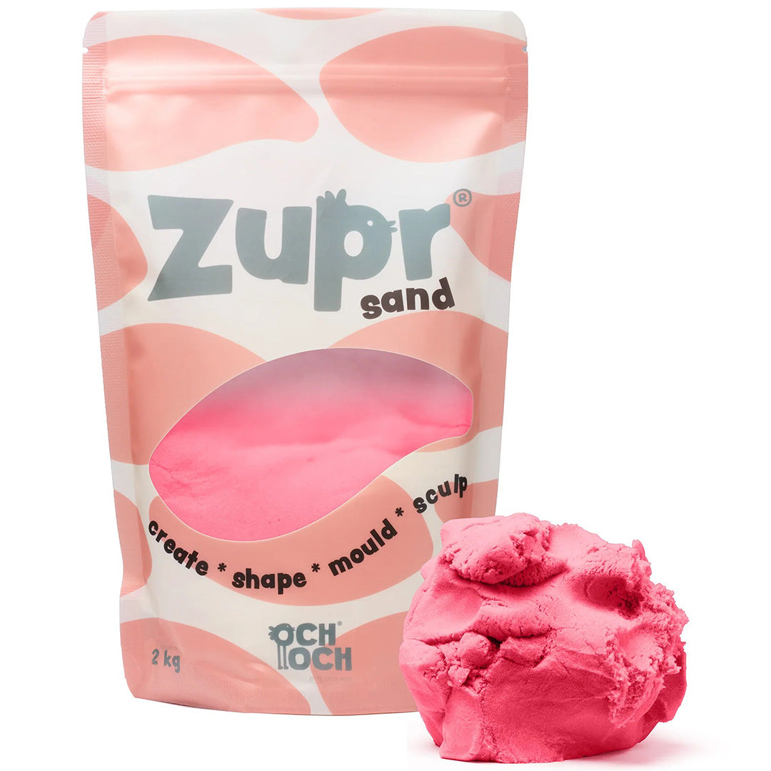 Och Och Zupr kinetisch zand in een roze verpakking met een hoopje roze zand ernaast.