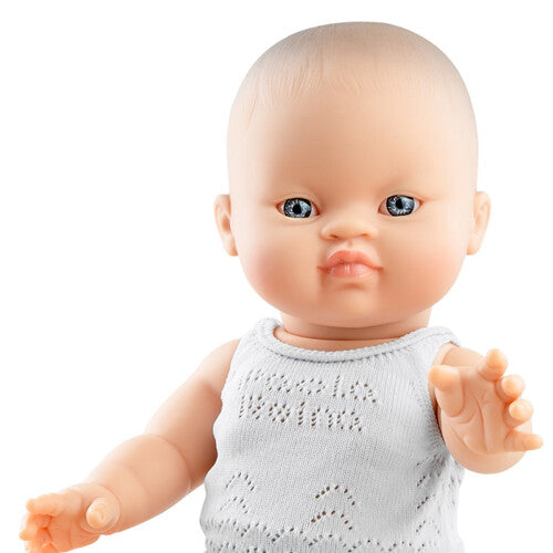 Detail van het gezicht en bovenlichaam van de Paola Reina babypop Gordi meisje met wit gebreid ondergoed.
