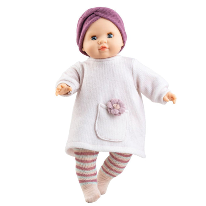 Paola Reina babypop Manus Laya met paarse muts, witte jurk met bloem en gestreepte legging.