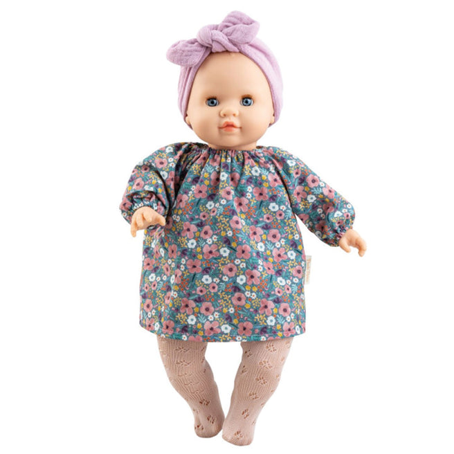 Paola Reina babypop met bloemenjurk, roze panty en paarse haarband.
