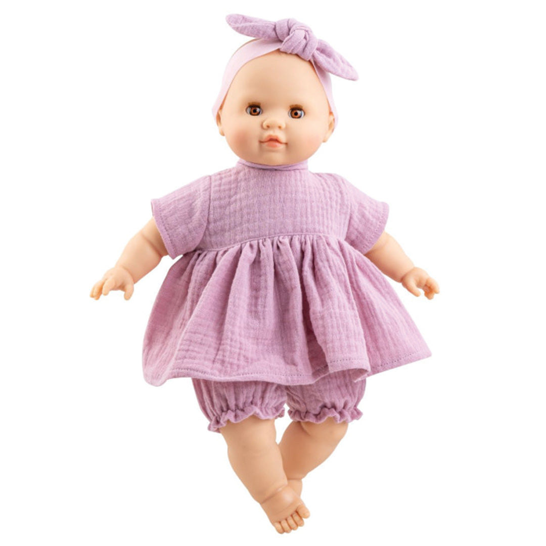 Paola Reina babypop met roze jurk en hoofdband.