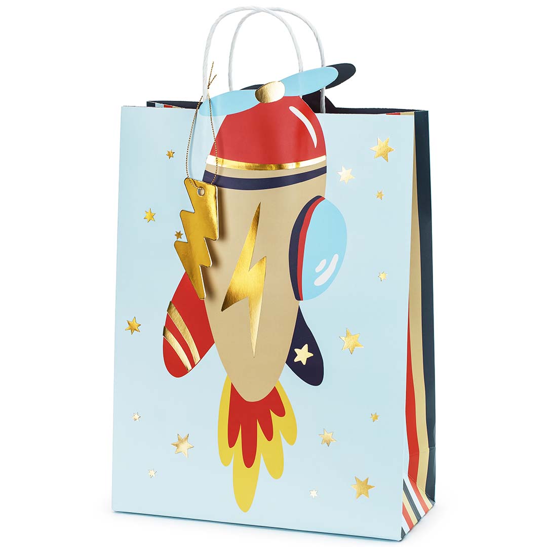 Partydeco cadeautasje met een raket en sterren op een lichtblauwe achtergrond.