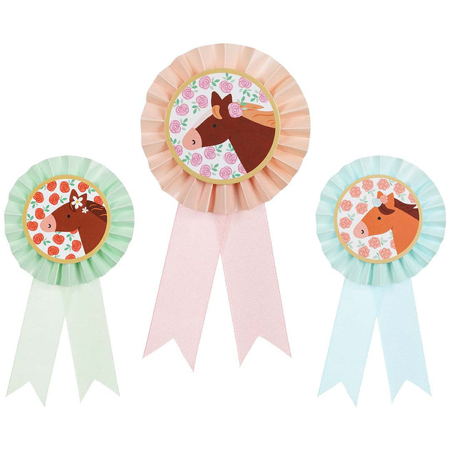 Drie Partydeco paarden rozetten in roze, lichtgroen en lichtblauw met bloemenpatroon.