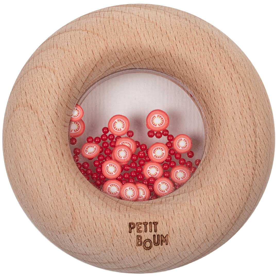 Petit Boum houten bijtring en rammelaar in donutvorm met rode tomatenfiguurtjes.