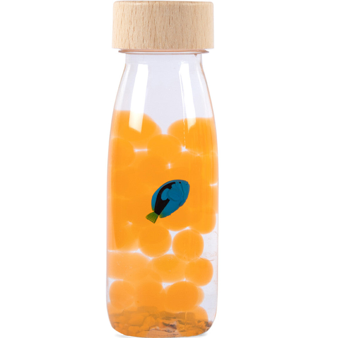 Petit Boum sensorische fles met oranje balletjes en een blauwe tang vis.