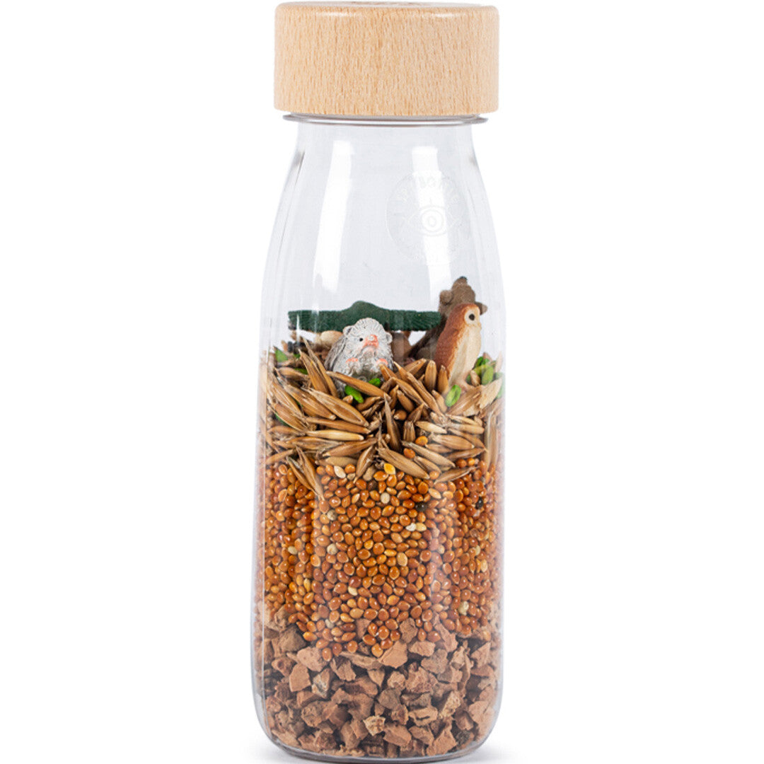 Petit Boum sensorische fles met bosdieren en verschillende zaden.