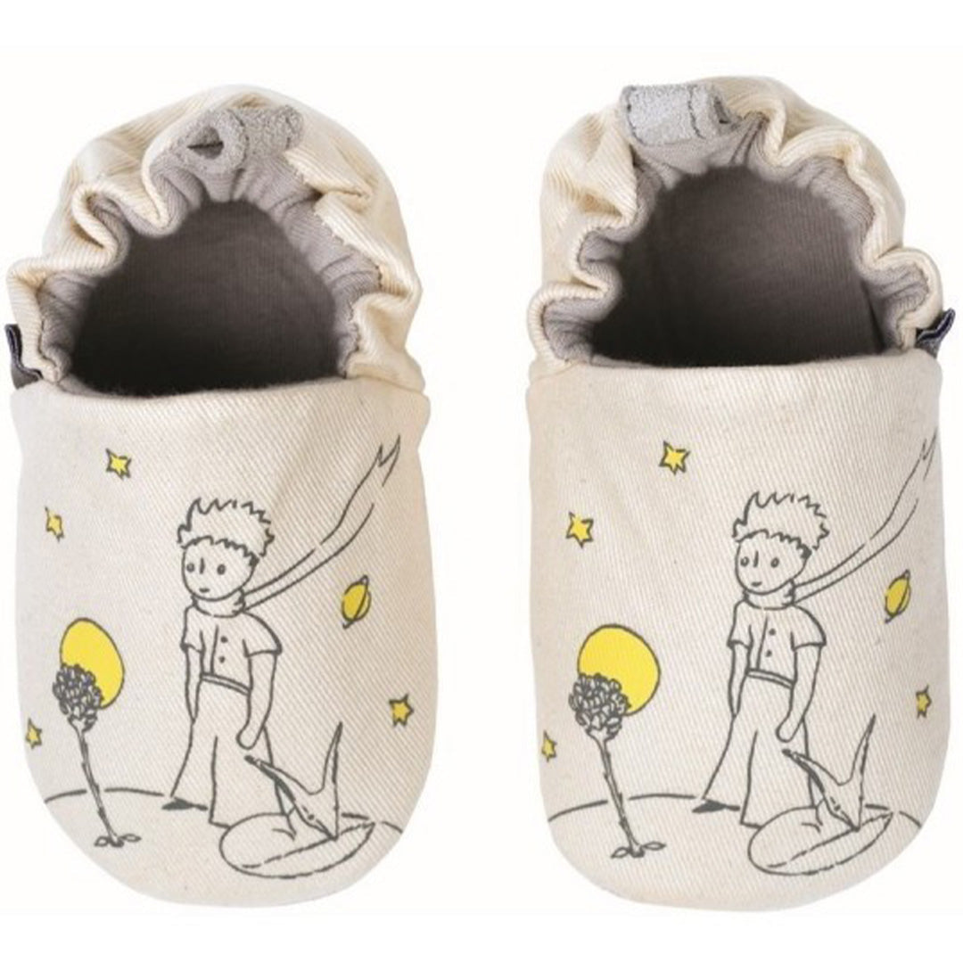 Twee beige petit jour baby schoentjes met zachte zool, bedrukt met Le Petit Prince, een vos en sterren.