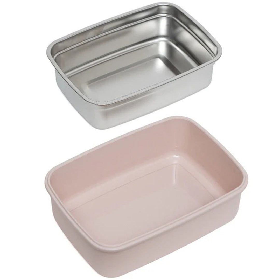 De losse roestvrijstalen binnenbak en de roze plastic buitenbak van de petit monkey bento broodtrommel.