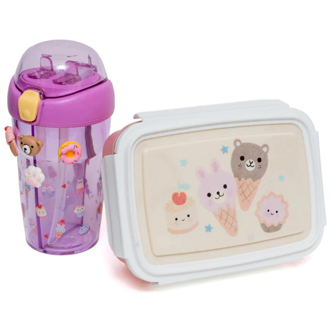 De petit monkey bento broodtrommel met ijsjes en cupcakes naast een paarse drinkfles.