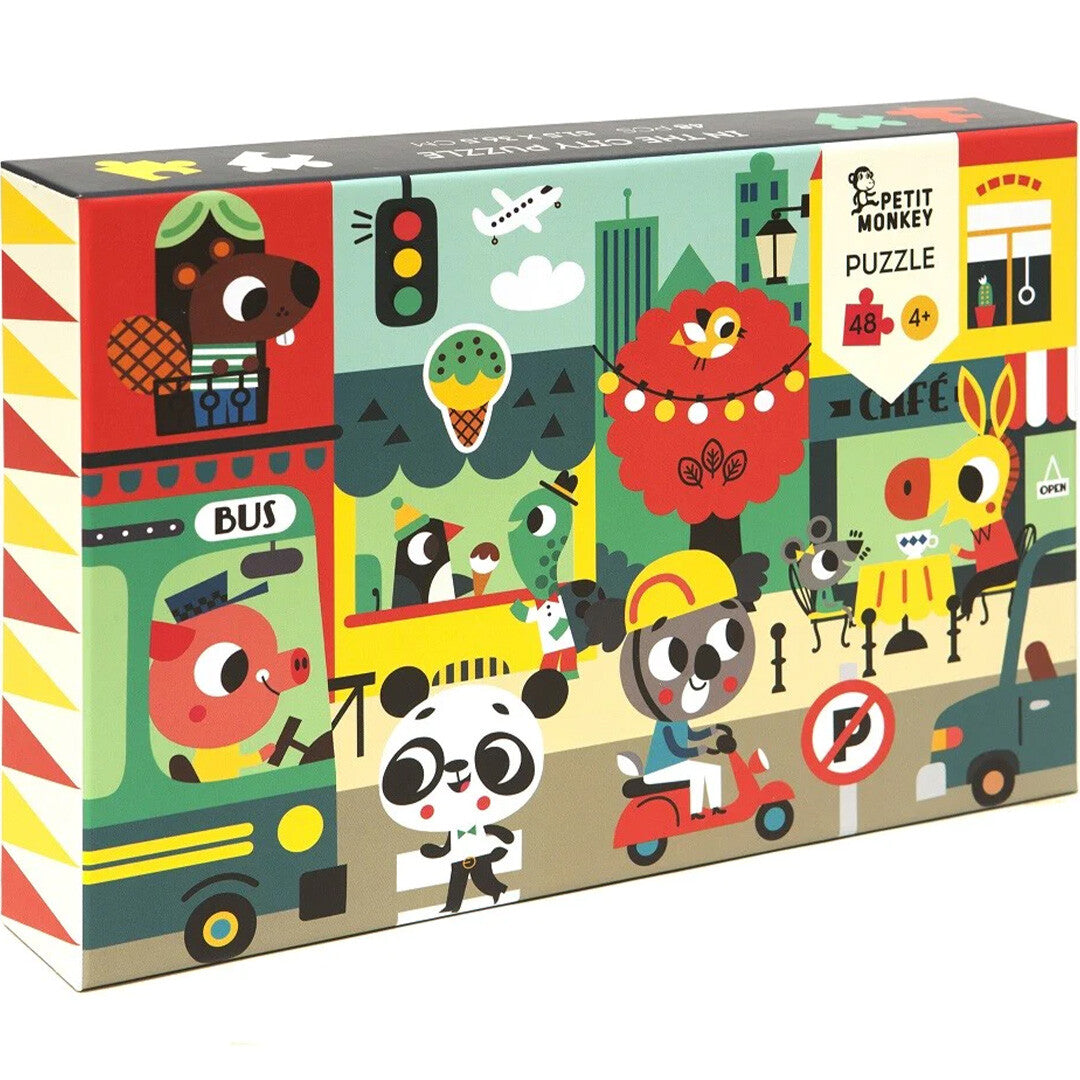 Petit Monkey puzzel 'In the City' verpakking met kleurrijke illustraties van dieren in een stad.