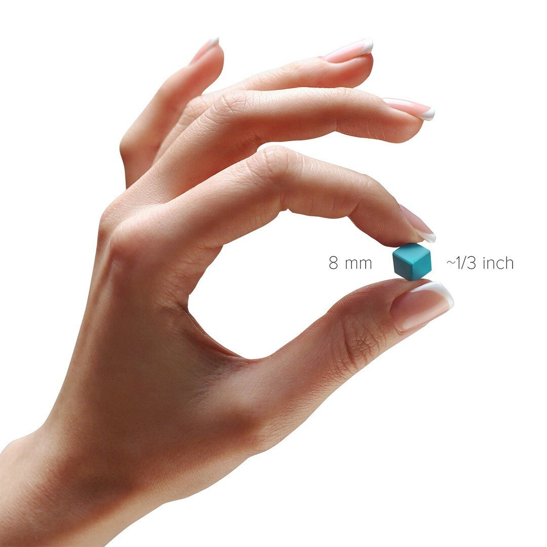 Een hand die een enkel blauw magnetisch blokje van 8 mm vasthoudt om de grootte te tonen.