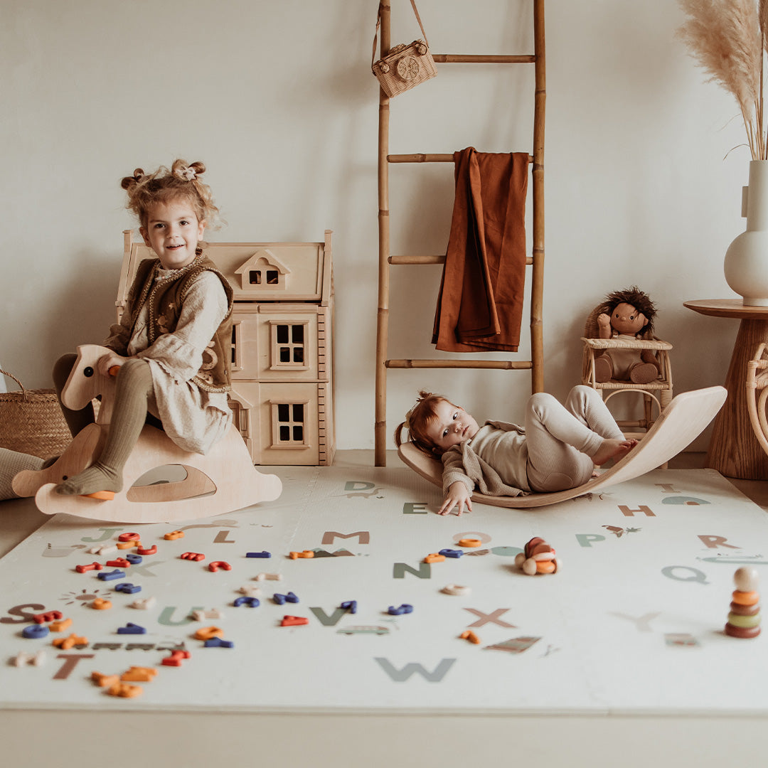 Twee kinderen spelen op de play&go foam speelmat met alfabetletters.