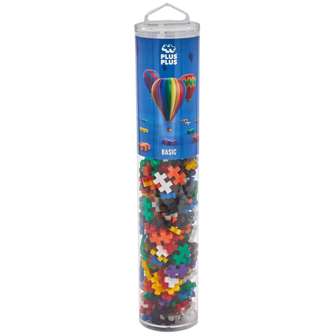 Plus-Plus bouwblokken basic mix in een transparante cilindervormige verpakking.