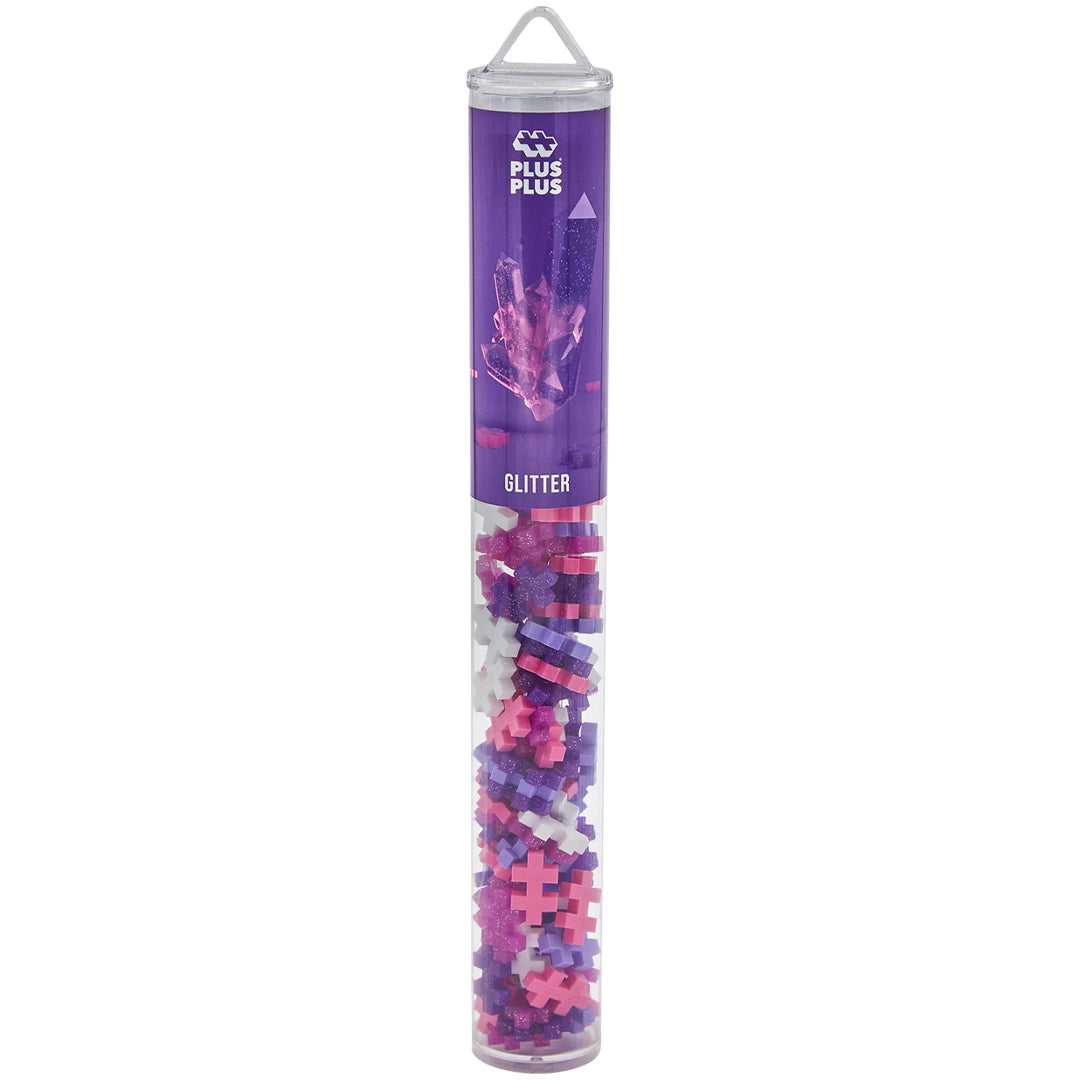 Plus-Plus glitter bouwblokken in een transparante verpakkingstube met paars etiket.