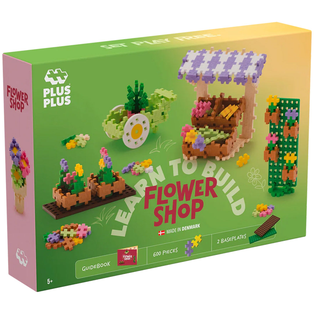 Plus-Plus bouwspeelgoed verpakking van de 'Learn to Build Flower Shop' set met voorbeelden van bloementhema creaties.