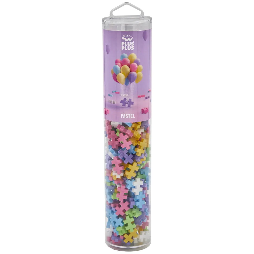 Plus-Plus bouwblokken in pastelkleuren, verpakt in een transparante koker.
