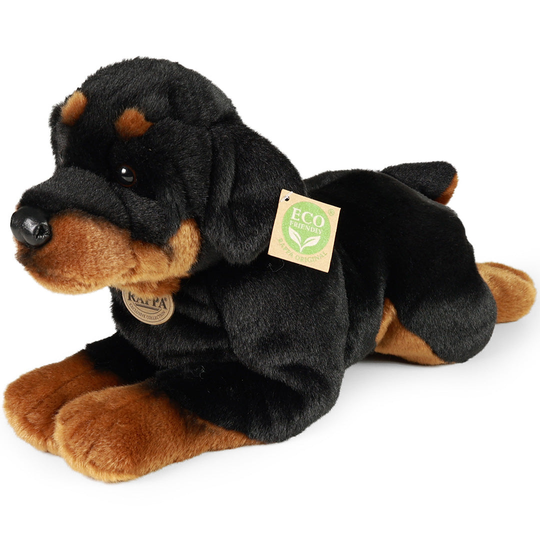 Rappa pluchen Rottweiler hond, liggend en schuin van voren gefotografeerd, met zichtbare labels.