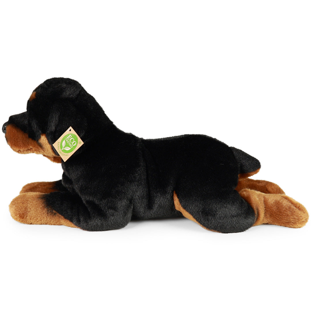Rappa pluchen Rottweiler hond, liggend en van de linkerzijkant gefotografeerd, met eco-label op de rug.