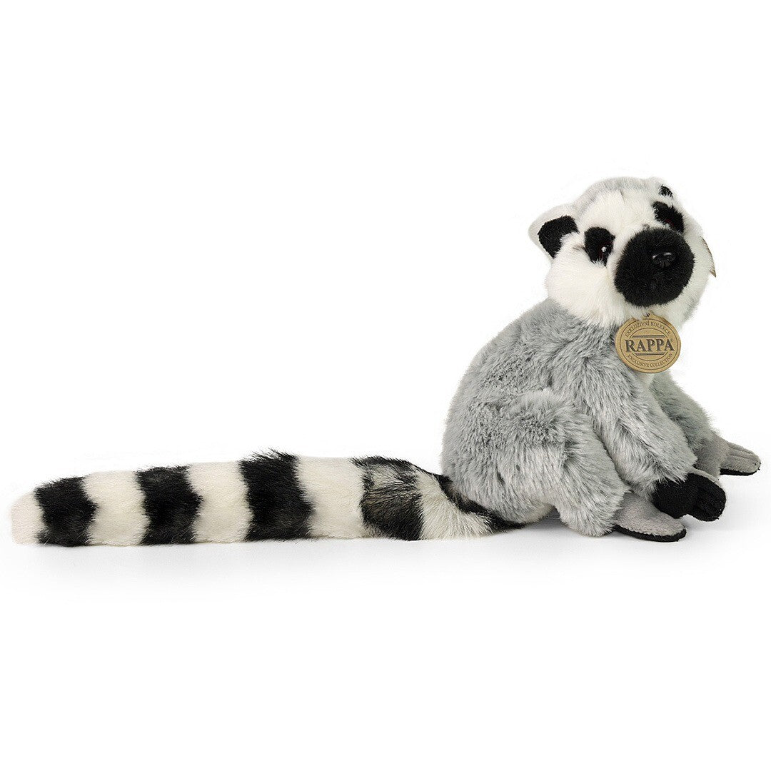 Rappa pluchen maki knuffel, zittend en van de zijkant gefotografeerd.