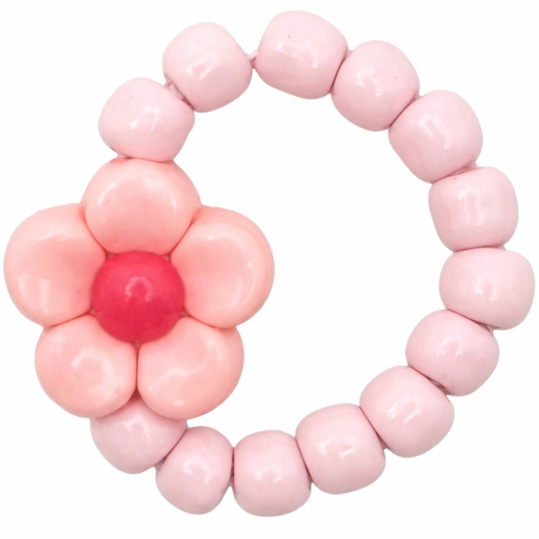 Ratatam kinderring met roze kralen en een roze bloem.