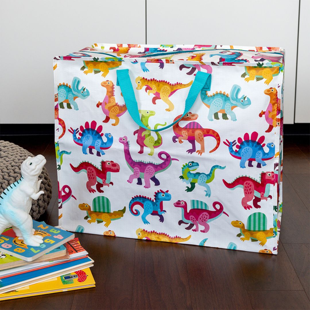 Rex London jumbo opbergtas met baby dinosaurussen op een houten vloer, met boeken en een dinosaurus speelgoedfiguur ernaast.