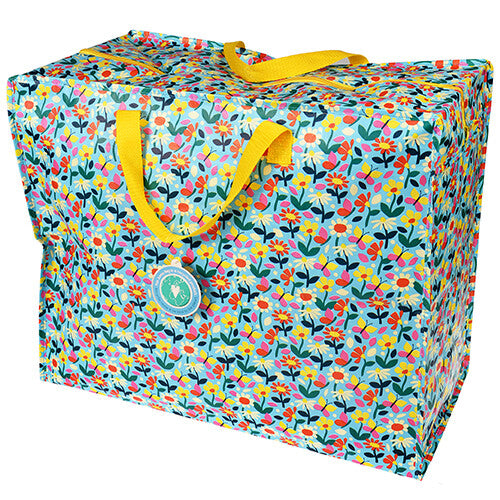 Rex London jumbo opbergtas met een kleurrijk bloemen- en vlinderpatroon en gele handvatten.
