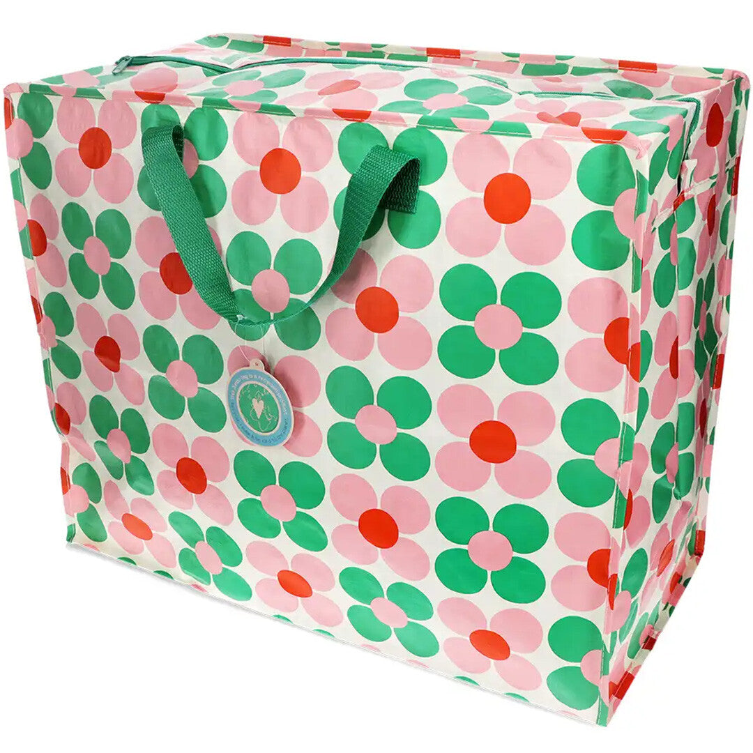 Rex London jumbo opbergtas van plastic met roze en groen margrietpatroon en groene handvatten.